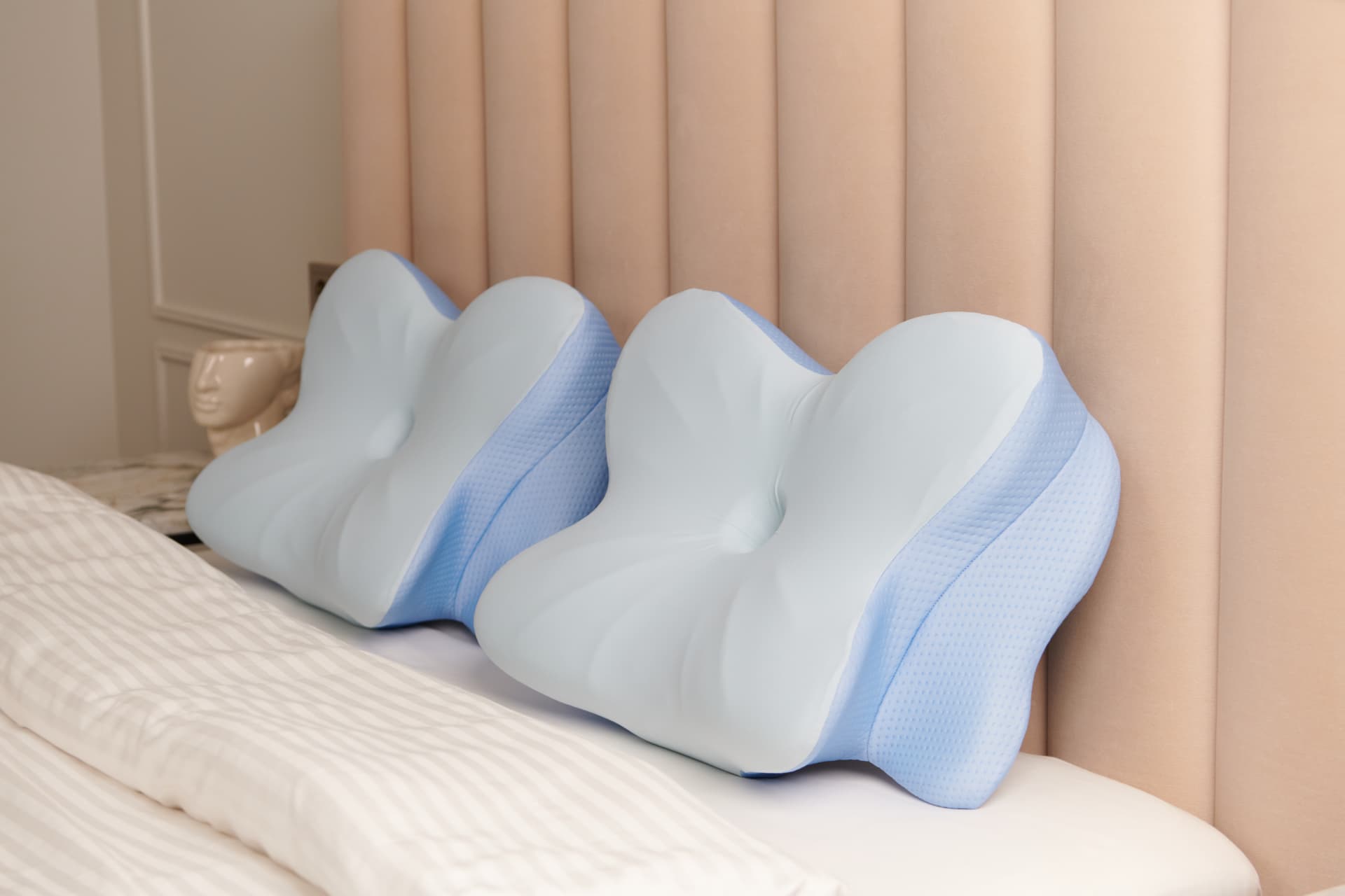 Two Derila Ergo ergonomic pillows resting on a bed